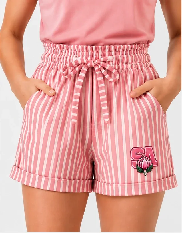 Pink and white striped shorts with a tie waist and a pink SA protea badge